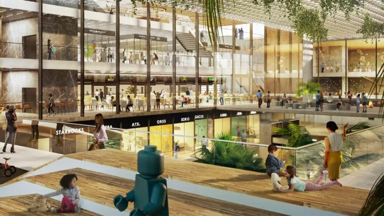 A multi-level, modern shopping mall or commercial complex interior.